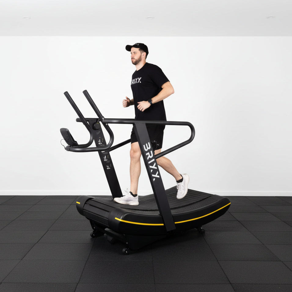 Person using a StairMaster exercise machine against a white backdrop