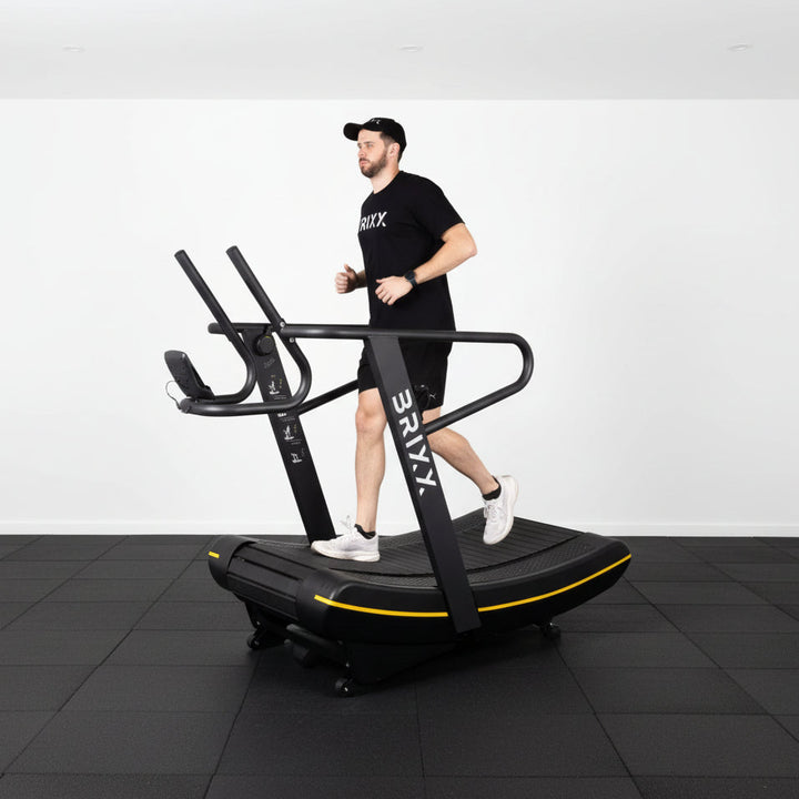 Person using a StairMaster exercise machine against a white backdrop