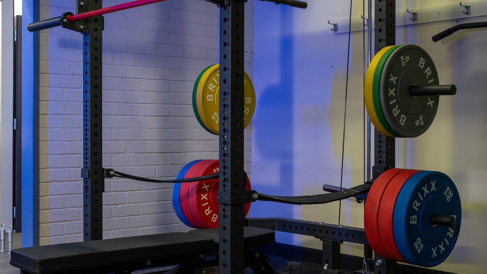 BRIXX power rack with lat pulley, colour bumper plates, Olympic barbell and adjustable bench